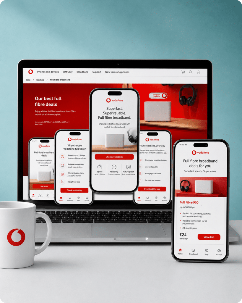 A mug, laptop and phone all displaying vodafone broadband